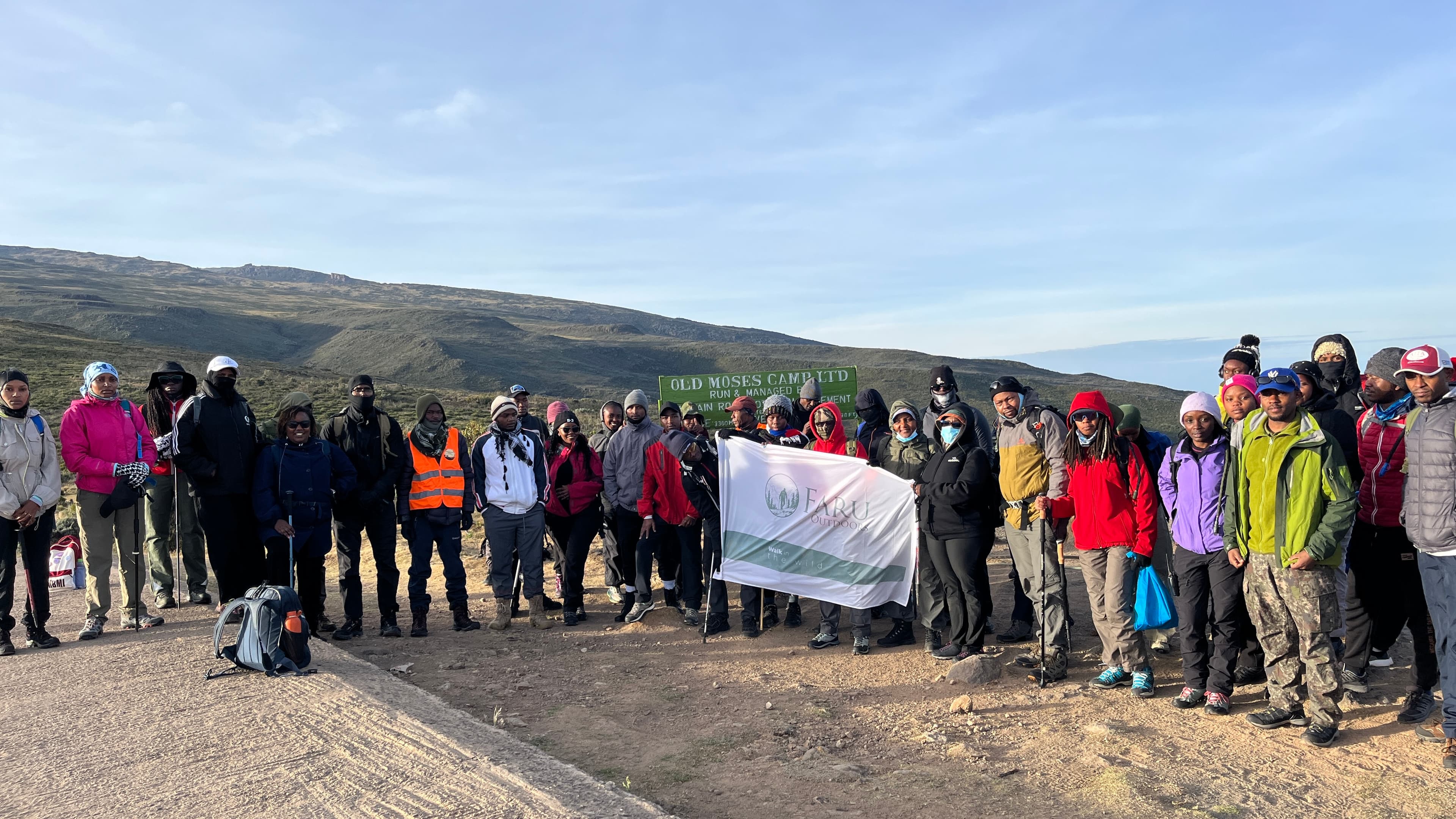 Hikers trekking through lush East African highlands